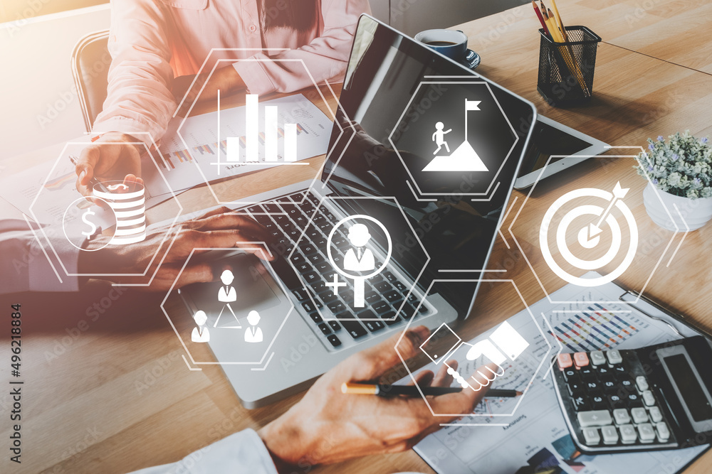 Business team discussing data with document data with VR screen quality management icon on desk table, Standardisation and certification concept.. Business team discussing data with document data with VR screen quality management icon on desk table, Standardisation and certification concept..