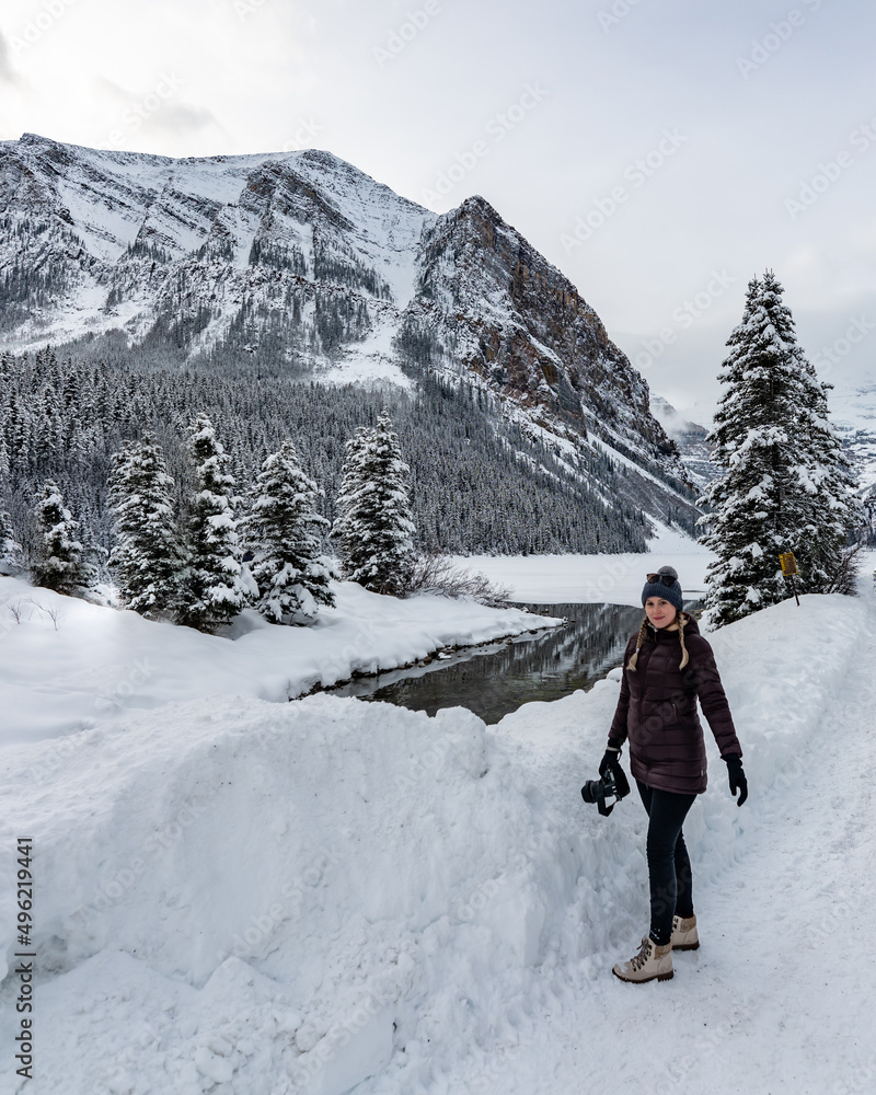 One person standing at Lake Louise in Alberta during winter with tourism, tourist shot vibe. One person standing at Lake Louise in Alberta during winter with tourism, tourist shot vibe.