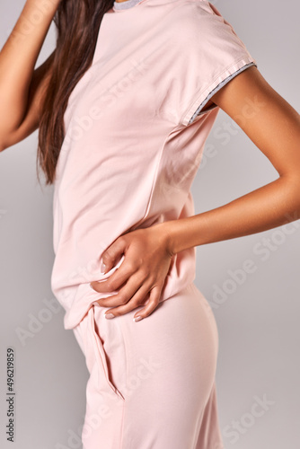 Wallpaper Mural Tanned girl in a pink suit on a white background Torontodigital.ca