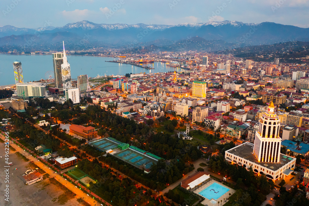 Aerial view of seaside district of large Georgian city of Batumi along Black Sea coast overlooking Alphabetic Tower, Technological University building and modern hotels at spring dusk
