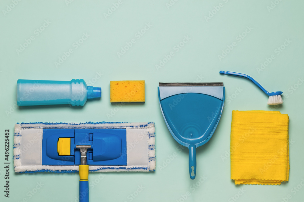 Classic cleaning kit on a blue background. Space for text. Flat lay. Classic cleaning kit on a blue background. Space for text. Flat lay.