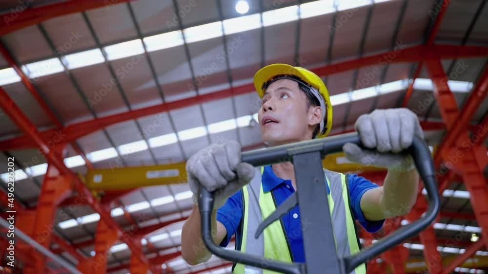 Asian male worker in a production line is dragging a cart inside the factory to carry out distribution work to a distribution center to serve customers.
Asian male worker in a production line is dragging a cart inside the factory to carry out distribution work to a distribution center to serve customers.