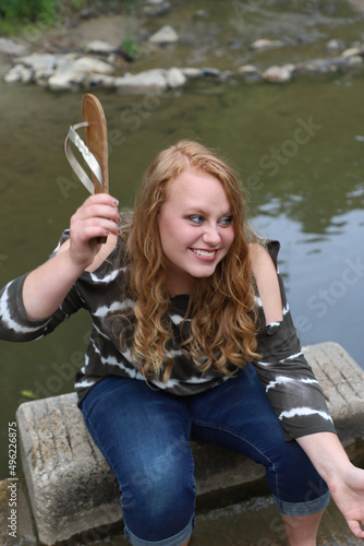 portrait of a girl holding a flip flop