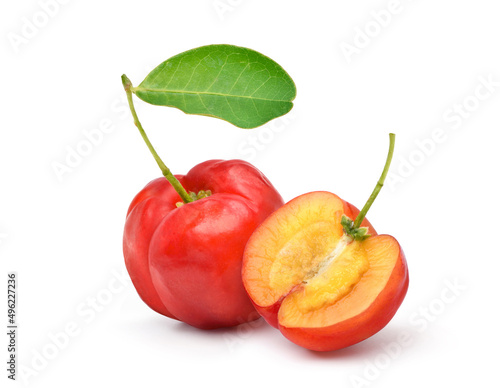 Juicy red Acerola cherry with cut in half isolated on white background.