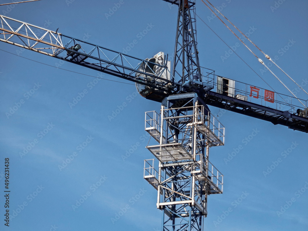 Construction crane against the blue sky. Industrial background. Construction site. Ust-Kamenogorsk (kazakhstan) Construction crane against the blue sky. Industrial background. Construction site. Ust-Kamenogorsk (kazakhstan)