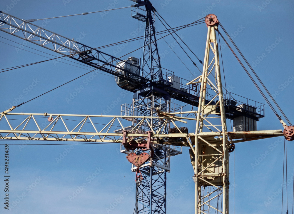 Construction cranes against the blue sky. Industrial background. Construction site. Ust-Kamenogorsk (kazakhstan)