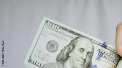 Caucasian female hand counting dollar banknotes cash load in a big close up with white background 