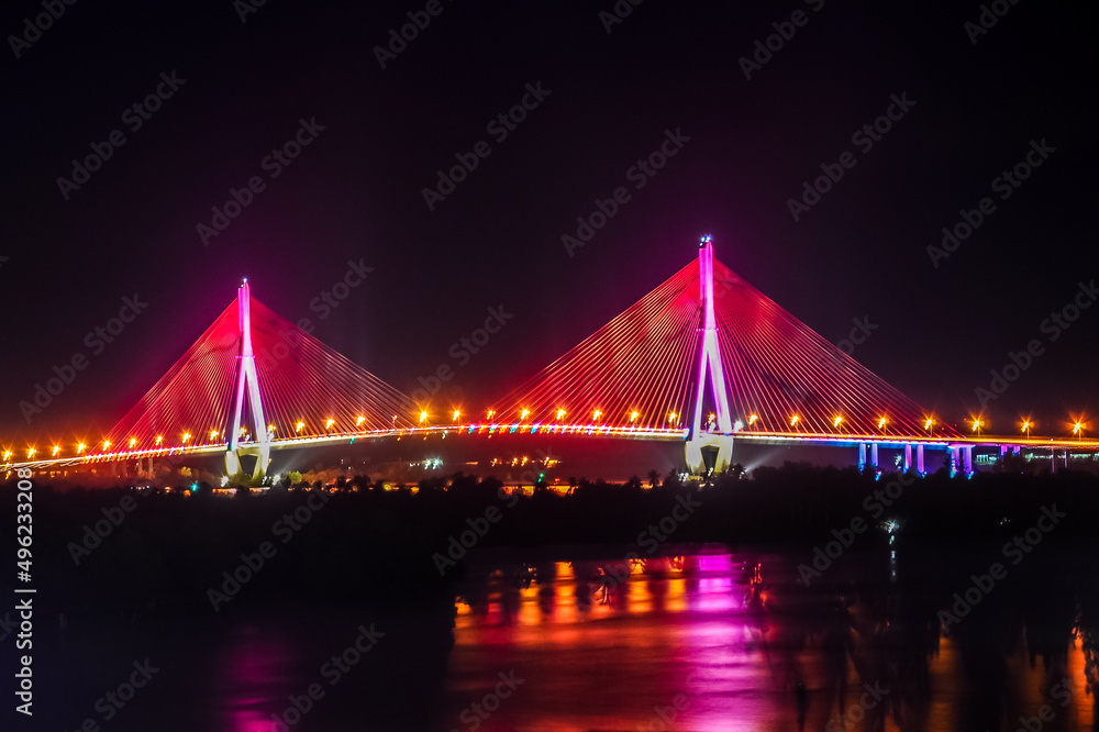 Naklejka premium Shimmering night lights by Can Tho bridge, Vietnam