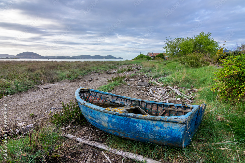 old blue boat aground on the regaton beach in Laredo, spain
