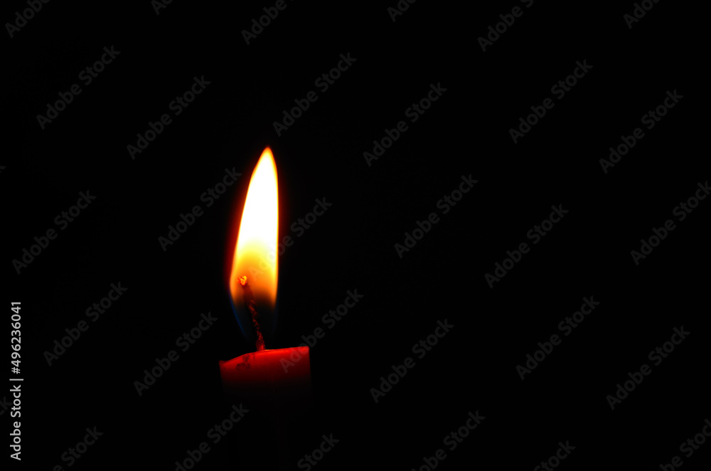 red candle on a bldetail view from a red burning candle in the black night during war red candle on a bldetail view from a red burning candle in the black night during war