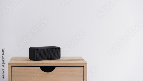Small rectangular music column on wooden nightstand