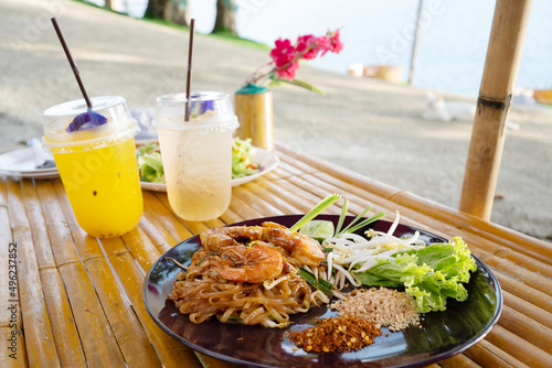 Orange juice on table seaside during sunset sky.