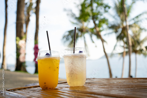 Orange juice on table seaside during sunset sky.