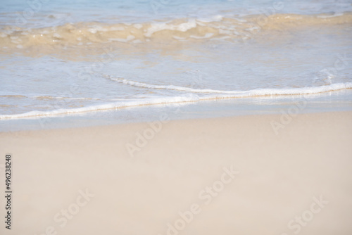 White sand waves texture lapping across untouched Shore.