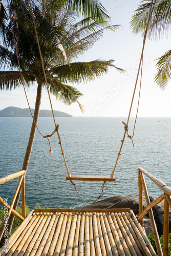Tropical island paradise beach coconut trees mountain background.