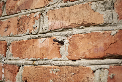 brick wall with a hammered nail background backdrop © сергей тарануха