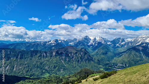 Mountain peak of Hahnkogel (Klek) with panoramic view in spring on the Karawanks, Carinthia, Austria. Borders Austria, Slovenia, Italy. Triglav National Park. Alpine meadows. Alm. Snow fields melting