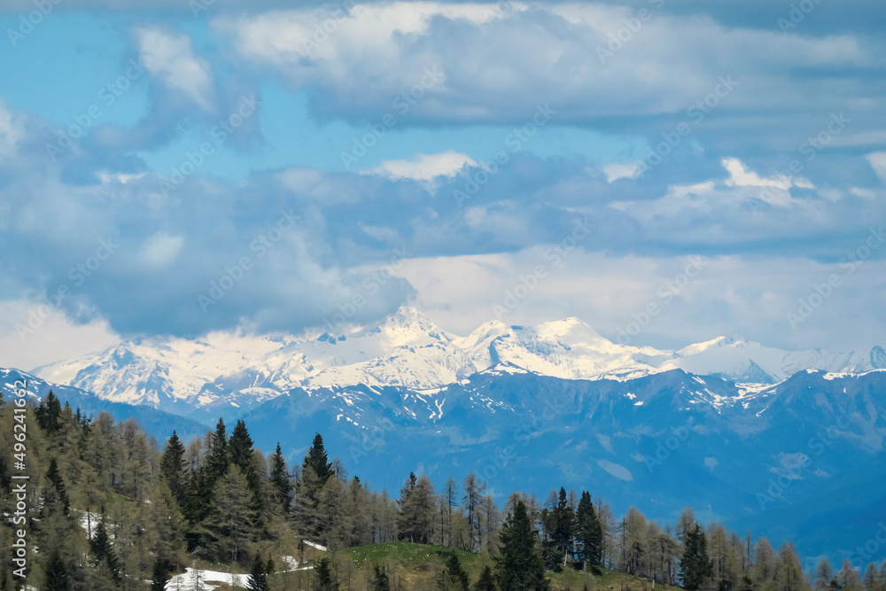Mountain peak of Hahnkogel (Klek) with panoramic view in spring on the Karawanks, Carinthia, Austria. Borders Austria, Slovenia, Italy. Triglav National Park. Alpine meadows. High grass