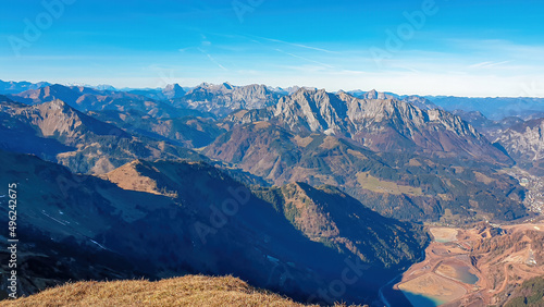 A panoramic view from mount Eisenerzer Reichenstein in Styria, Austria, Europe. Austrian Alps. View on the village Eisenerz and the lakes in the Ennstal valley. Hiking trail, Wanderlust. Sunny day © Chris