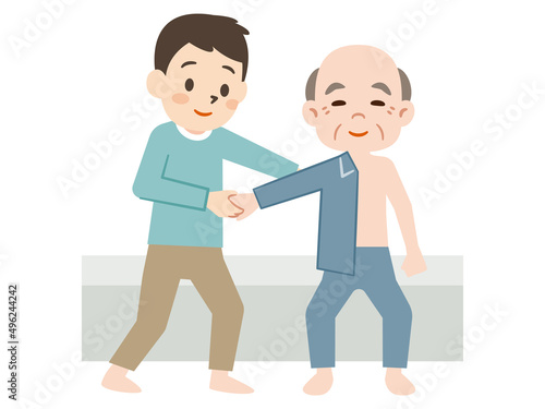 高齢者の着替えをサポートする男性