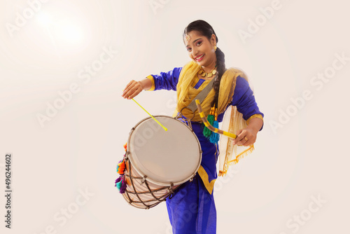 Portrait of Sikh woman playing drum during Baisakhi celebration photo
