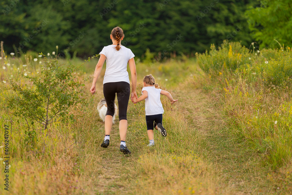 mother and daughter walking in nature