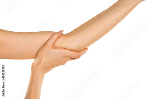 Woman with painful elbow on a white background