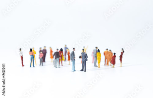 Group of miniature people meeting on white background. closeup.