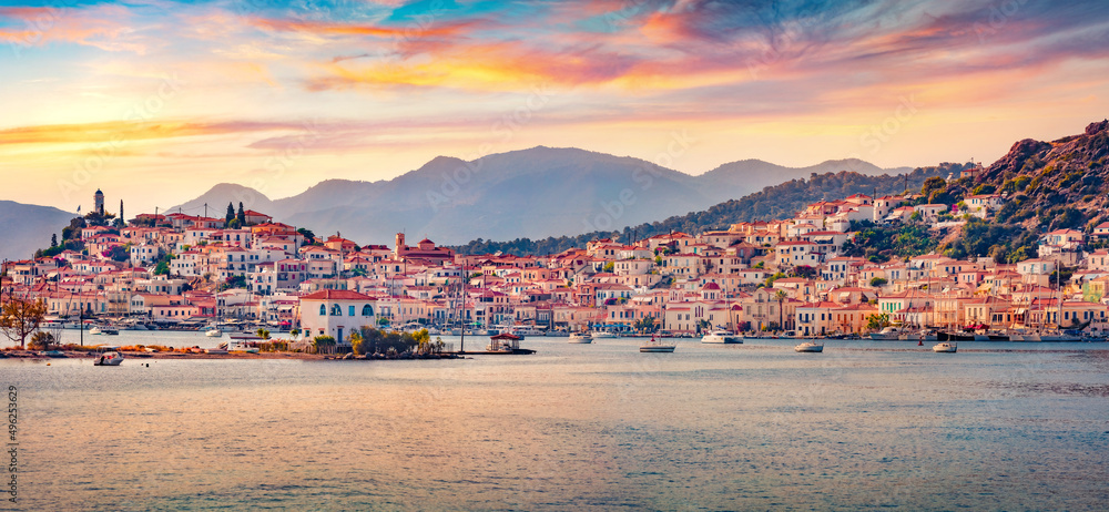 Panoramic morning cityscape of Poros town, Greece, Europe. Stunning summer sunrise on Myrtoan Sea. Traveling concept background.