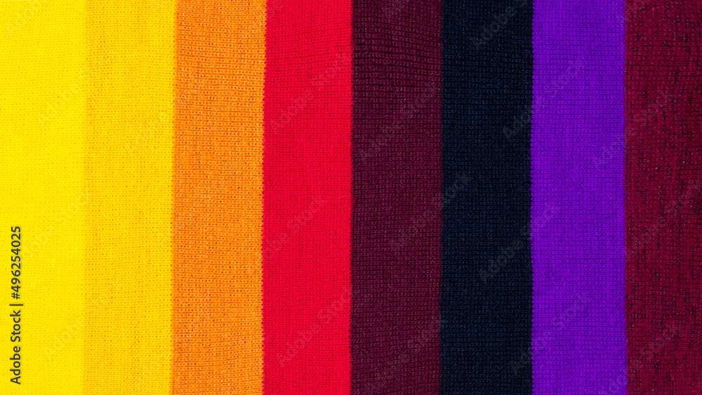 Fototapeta premium multi colored background. knitted wool fabric texture with stripes