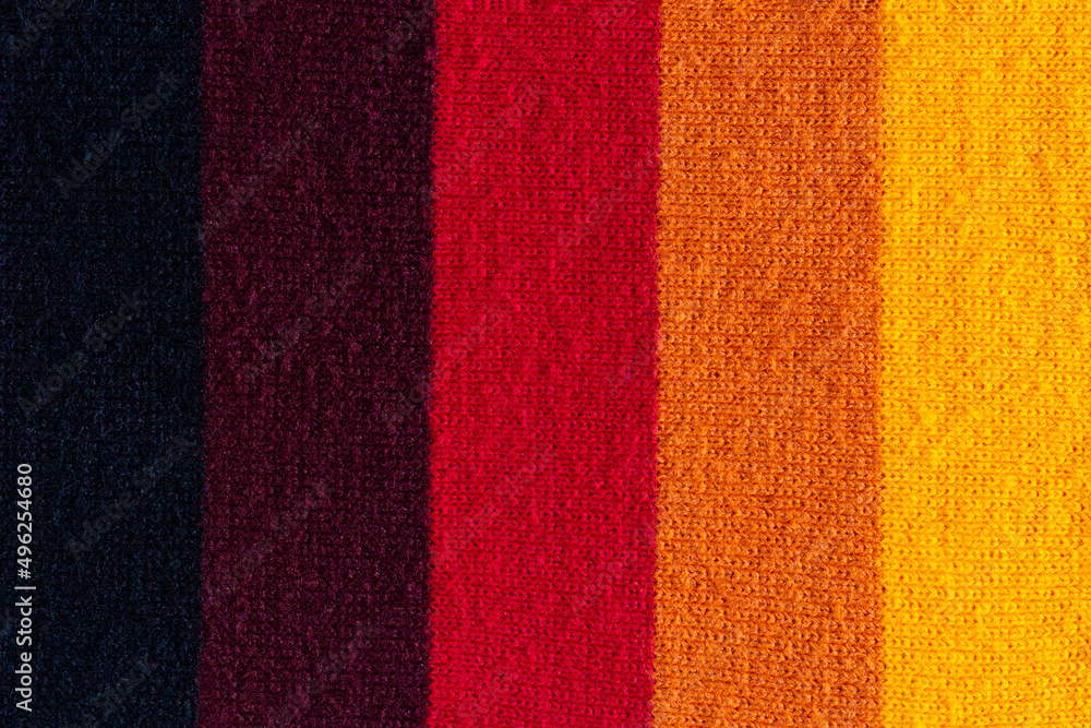 Fototapeta premium multi colored background. knitted wool fabric texture with stripes