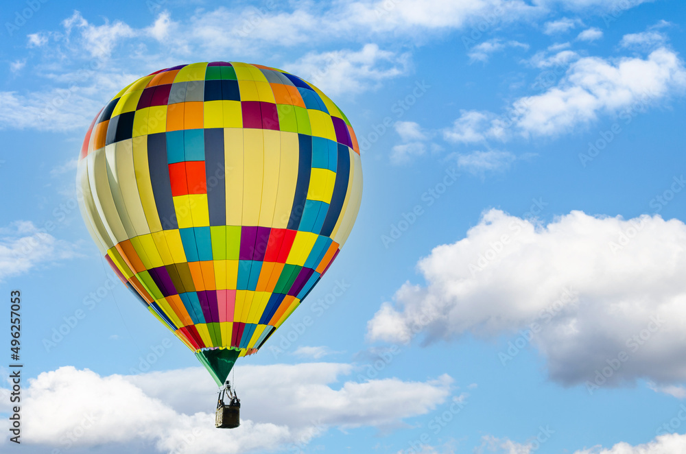 Colorful hot air balloon flying over blue sky Colorful hot air balloon flying over blue sky