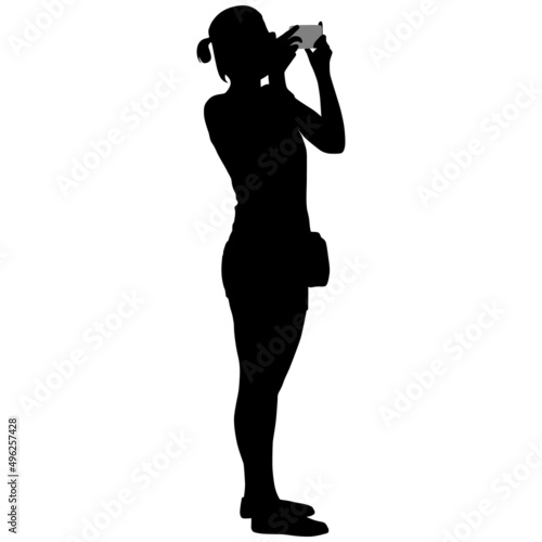 Black silhouette of woman in shorts with phone in her hands