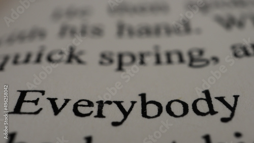 Everybody text in open book page, close up, macro shot of everybody word, education and novel concept, selective focus photo