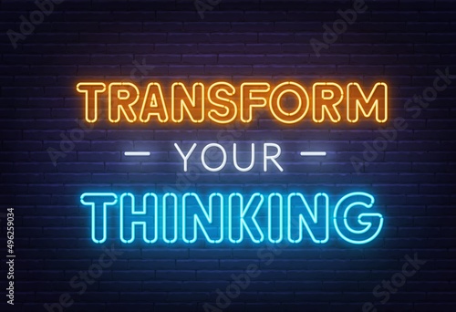 Transform your thinking neon lettering on brick wall background.