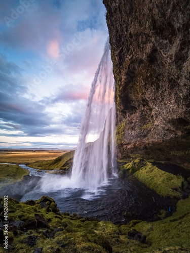 Seljalandsfoss waterfall wide angle at dawn, vertical composition