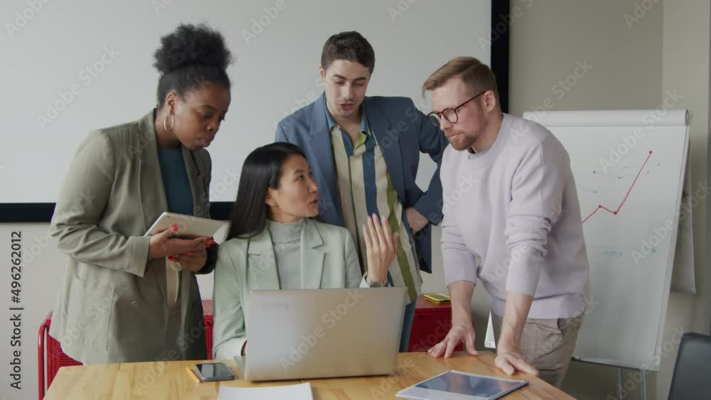 Business team working together on project in office Business team working together on project in office