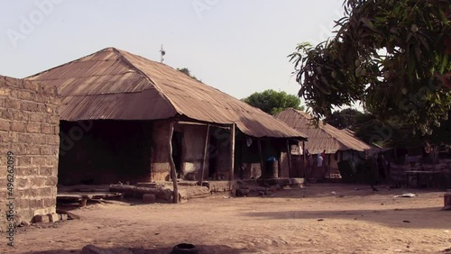 Traditional Guinean houses, built with adobe blocks and roof with old zinc sheets photo