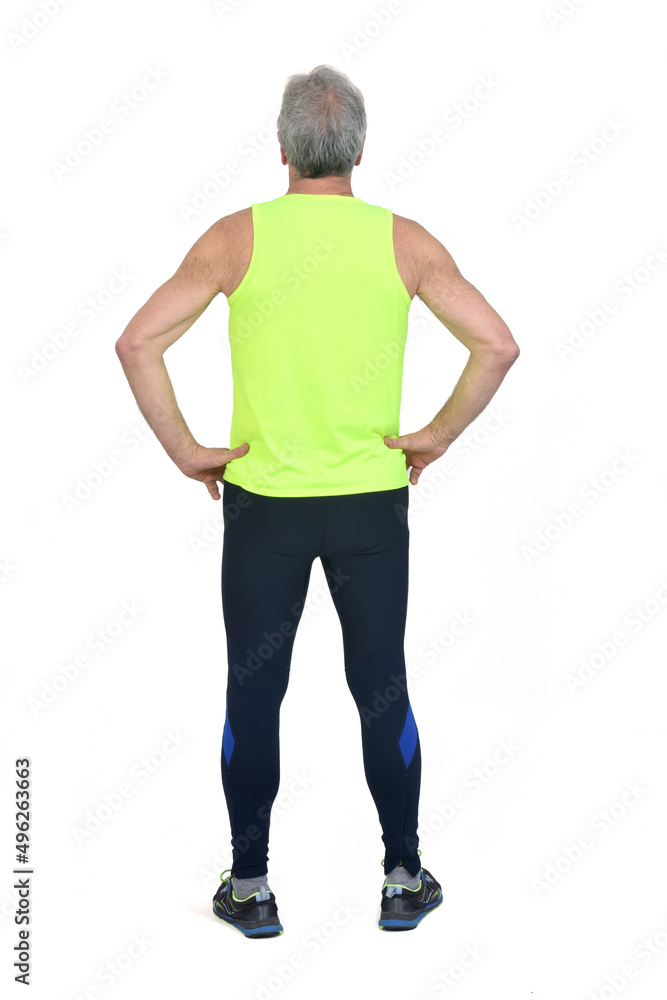 back view of a man in sportswear tights and fluorescent yellow ,hands on hip on white background