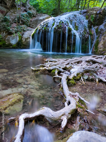 beautiful waterfall in the mountain gorge