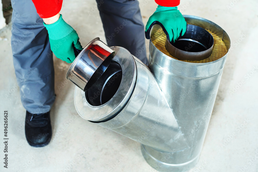 Installation of the chimney and ventilation system. Metal part with stone  wool insulation. The process of fitting a double pipe. Close-up Stock Photo  | Adobe Stock