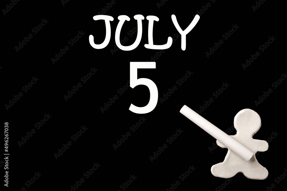 A small white plasticine man writing the date 5July on a black board. Business concept. Education concept. A small white plasticine man writing the date 5July on a black board. Business concept. Education concept.