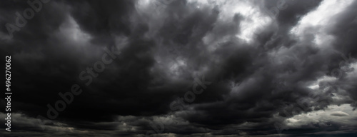 black clouds. Before a heavy rainstorm, the sky was covered with clouds with lightning and strong winds, the dark clouds looked like huge black smoke from an erupting volcano.