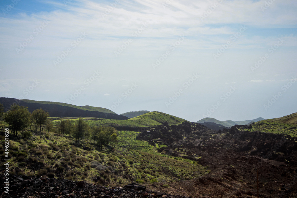 Fototapeta premium Volcanic ground on curvy road to Pico do Fogo, volcano on the island of Fogo on Cabo Verde islands. Looking towards the top of the mountain.