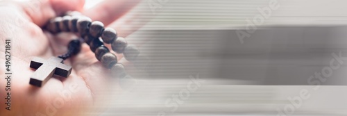 Wallpaper Mural Blur effect with copy space against close up of a hand holding a rosary Torontodigital.ca