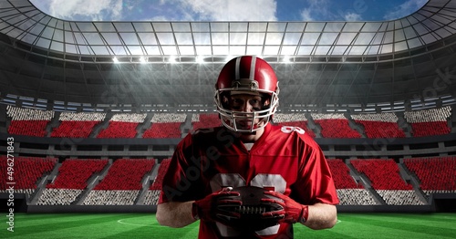 Composite image of caucasian male rugby player holding a rugby ball against sports stadium