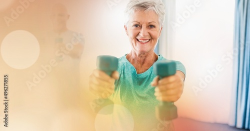 Blur effect with copy space against portrait of caucasian senior woman working out with dumbbells