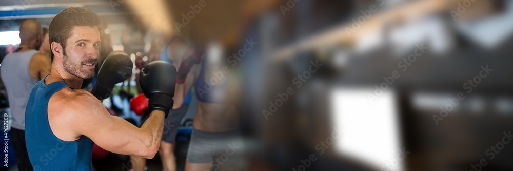 Blur effect with copy space against portrait of caucasian male boxer at the gym Blur effect with copy space against portrait of caucasian male boxer at the gym