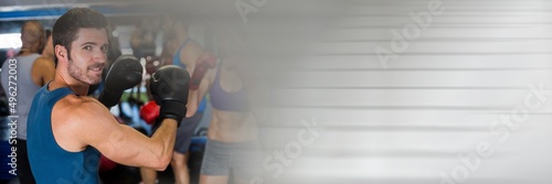 Blur effect with copy space against portrait of caucasian male boxer at the gym