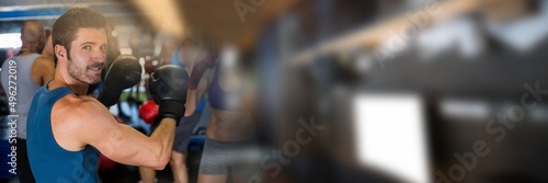 Blur effect with copy space against portrait of caucasian male boxer at the gym